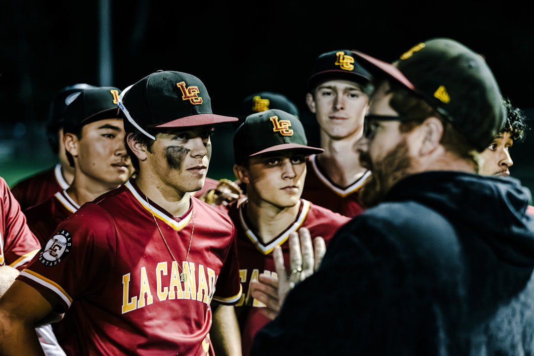 certified service dog trainer — Baseball team huddles with coach during game