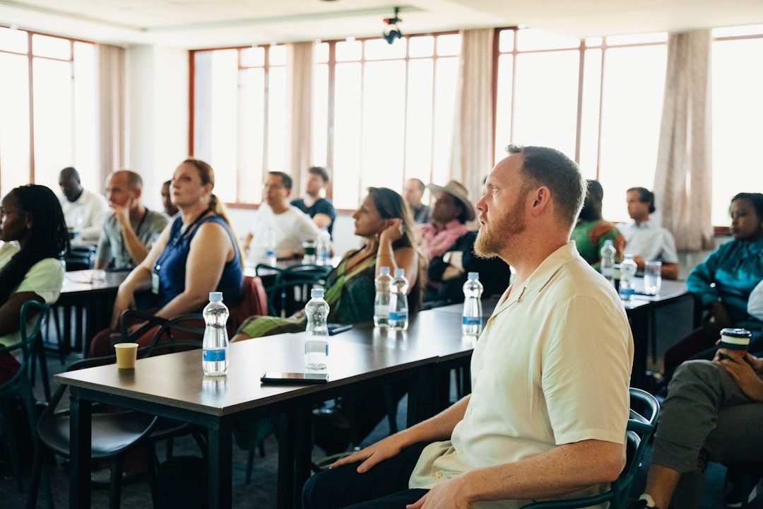 client communication skills — Diverse group of people attending a presentation in-person conference